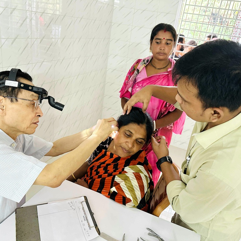 ENT Doctor treating a patient.