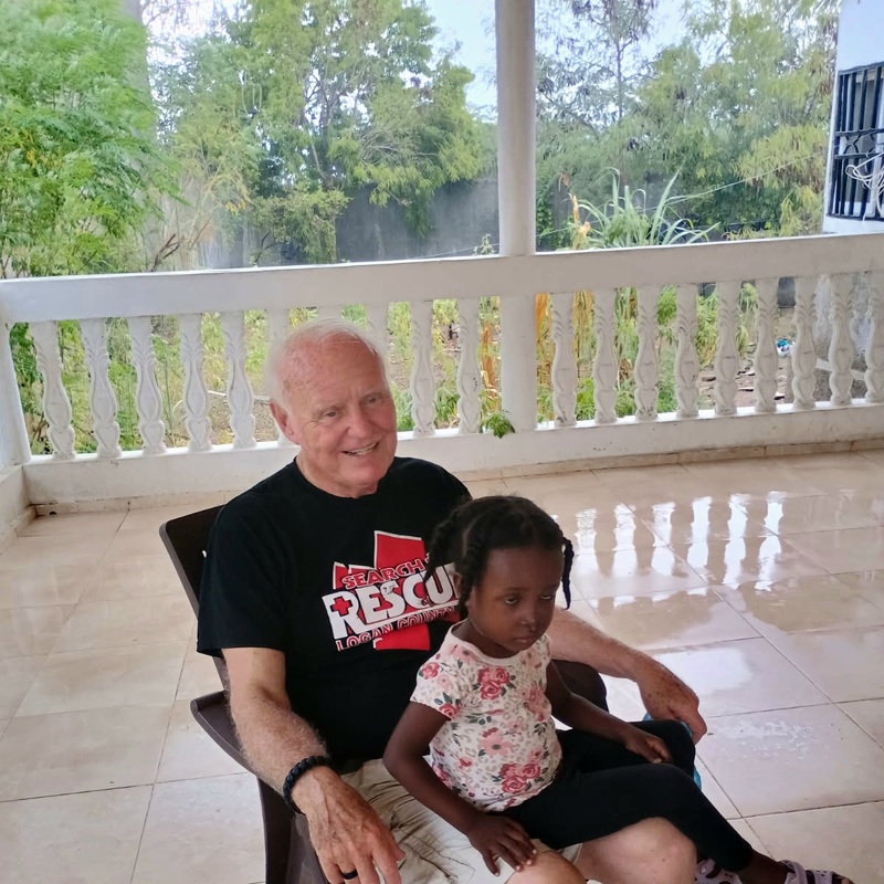 Mike Humble with a child at the House of Love September 2025